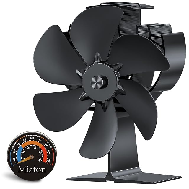 Black anodised Miaton stove fan with six angled blades beside a round magnetic stove thermometer