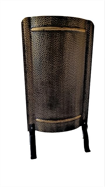 A black-gold hammered steel stove screen on feet, 91 by 46 centimetres